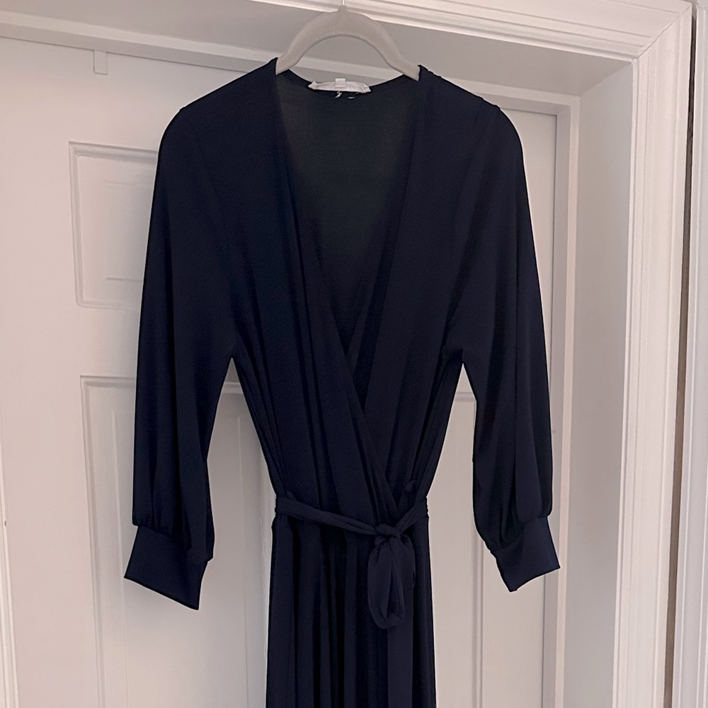Floor length faux wrap-style dark navy jersey dress/gown with tie belt.